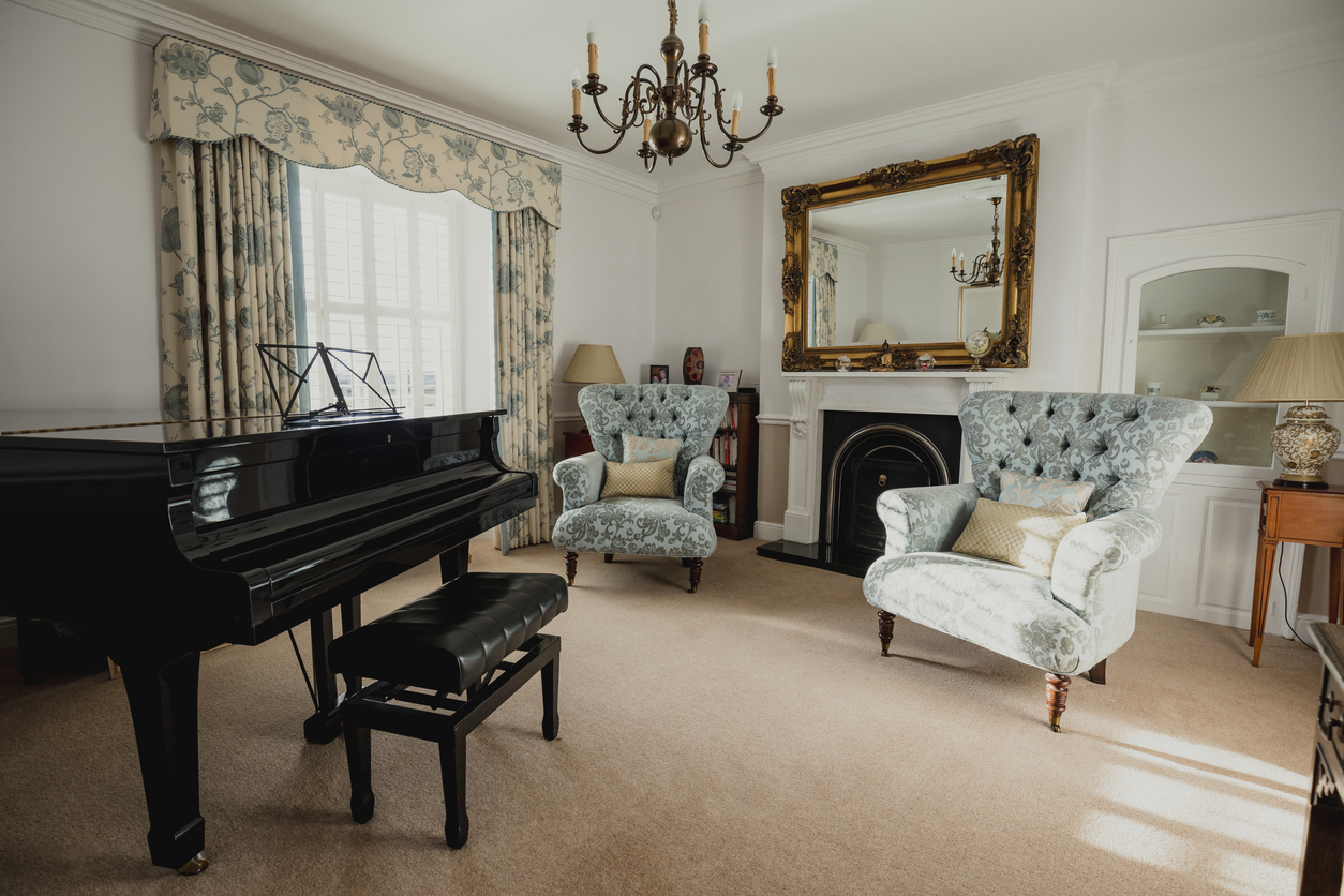 room with piano and upholstered chairs