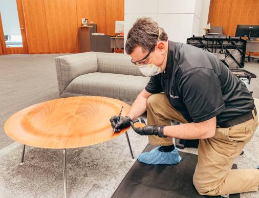 Woodlord restoration expert restoring a wooden table